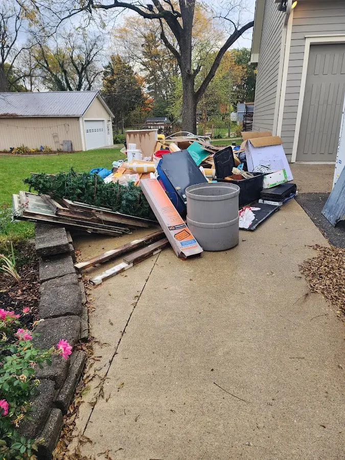 Dumpster being loaded with debris for Commercial Dumpster Rental in New Gloucester
